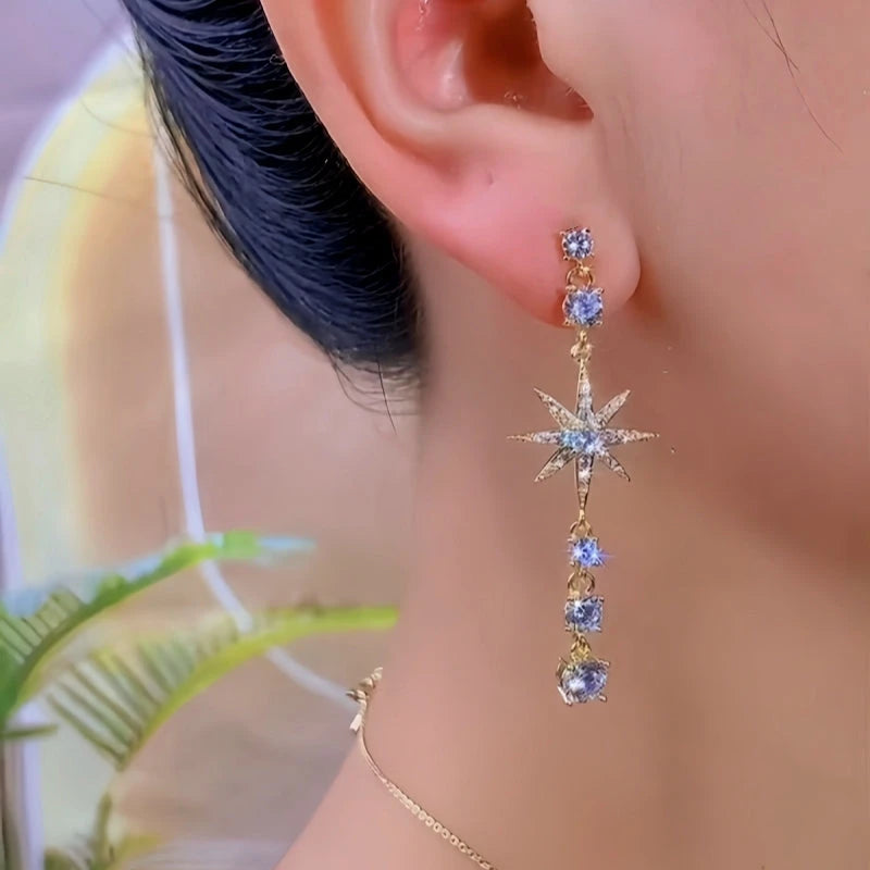 Close-up detail of the sparkling zircons and plating on the gold tassel earrings