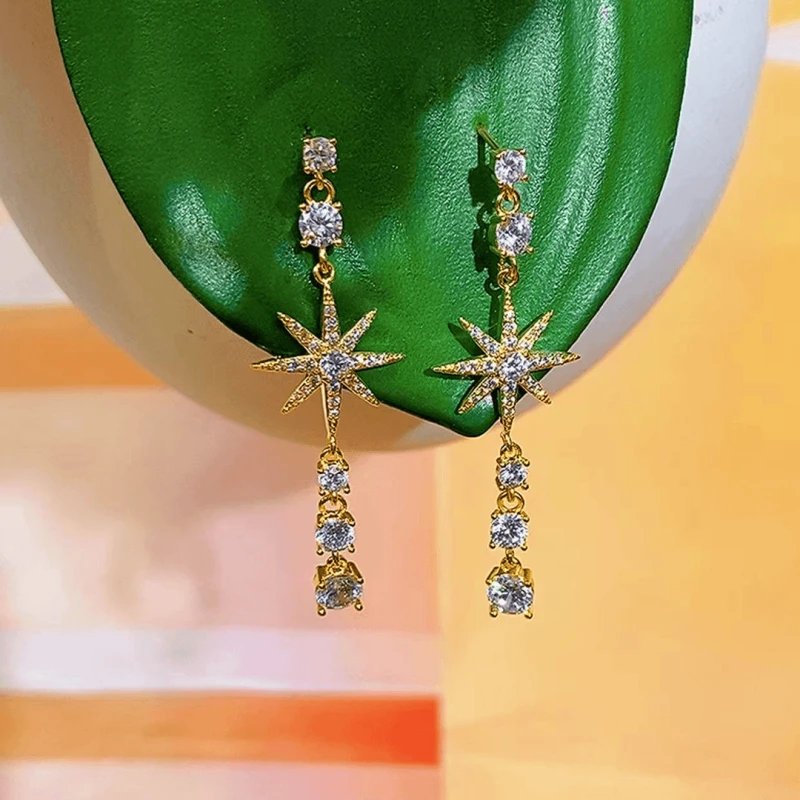 Angled view of the 14K Gold-Plated Elegant Zircon Full Diamond Star Tassel Earrings