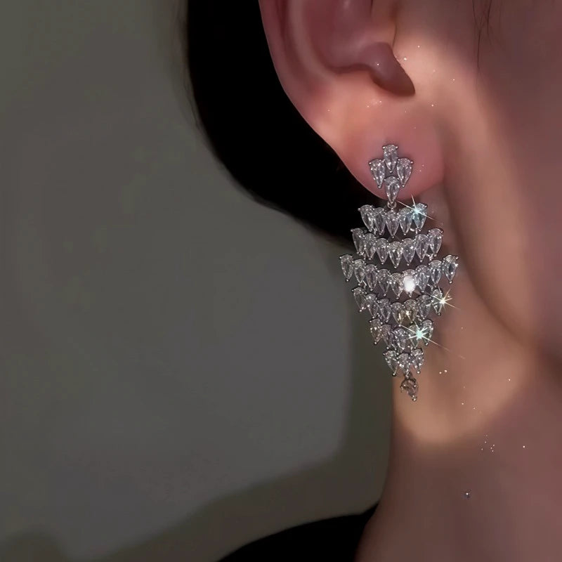Model showcasing the dangle and style of the 14K Gold-Plated Elegant Zircon Full Diamond Tassel Earrings