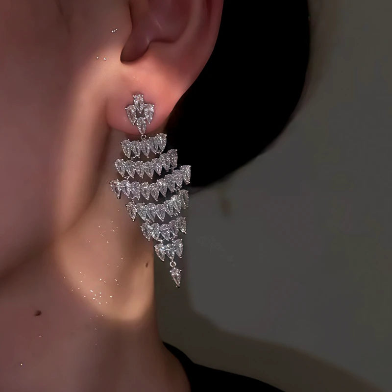 Close-up detail of the sparkling zircons and plating on the silver tassel earrings