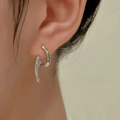 Close-up detail of the sparkling zircons and plating on the silver geometric earrings