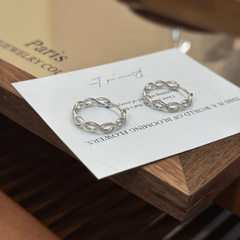 Close-up detail of the sparkling zircons and plating on the silver hoop earrings