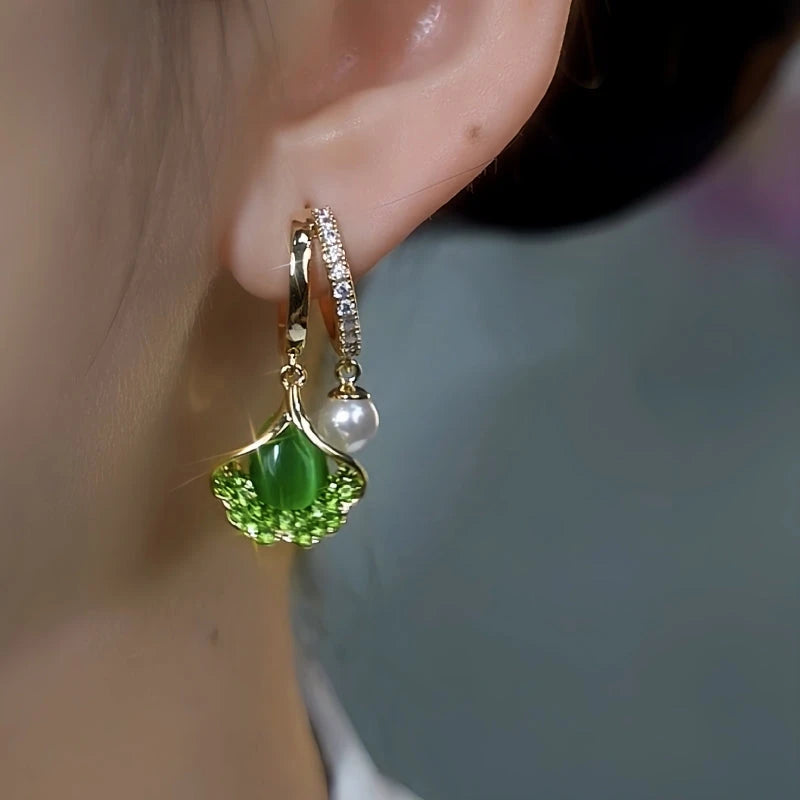 Close-up detail of the sparkling zircons and plating on the gold leaf earrings