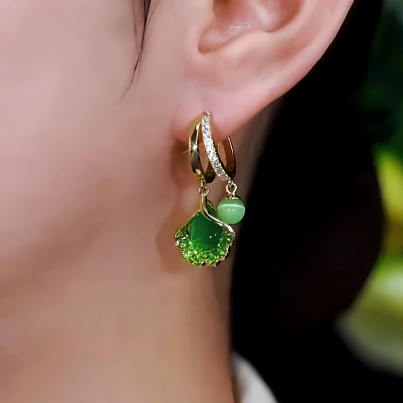 Close-up detail of the sparkling zircons and plating on the gold leaf earrings