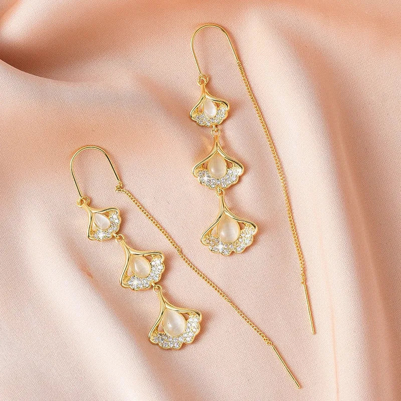 Close-up detail of the sparkling zircons and plating on the gold threader earrings