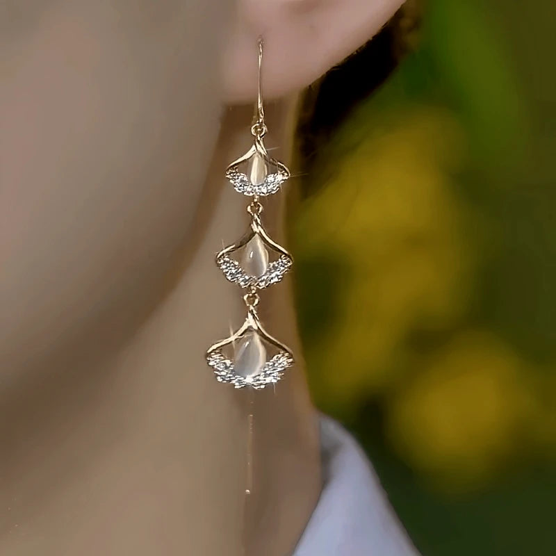 Model showcasing the dangle and style of the 14K Gold-Plated Elegant Zircon Ginkgo Leaf Threader Earrings