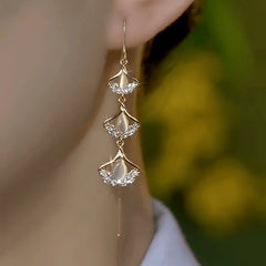 Model showcasing the dangle and style of the 14K Gold-Plated Elegant Zircon Ginkgo Leaf Threader Earrings