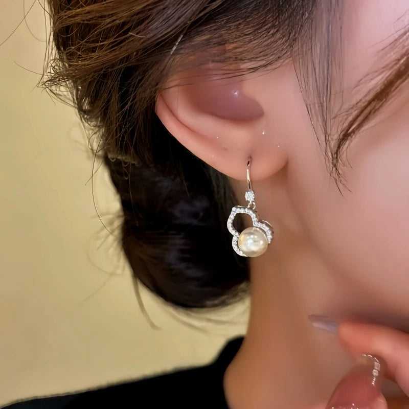 Close-up detail of the sparkling zircons and plating on the gold threader earrings