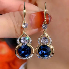 Model showcasing the dangle and style of the 14K Gold-Plated Elegant Zircon Gourd Ear Hook Earrings