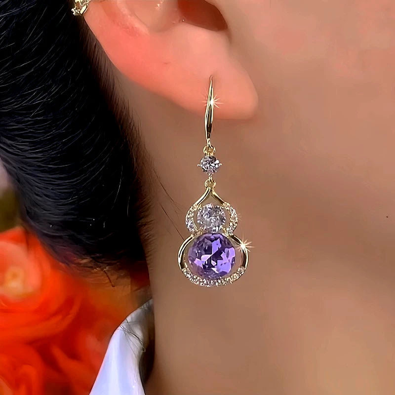 Close-up detail of the sparkling zircons and plating on the gold threader earrings