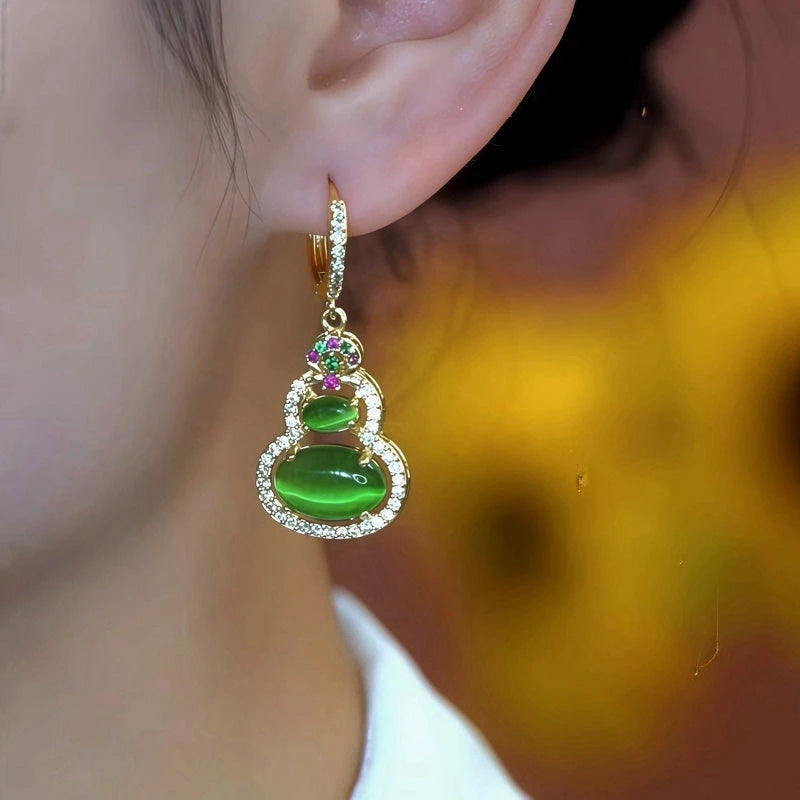 Close-up detail of the sparkling zircons and plating on the green drop earrings