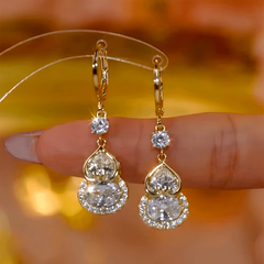 Close-up detail of the sparkling zircons and plating on the gold drop earrings