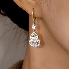 Model showcasing the dangle and style of the 14K Gold-Plated Elegant Zircon Gourd Earrings