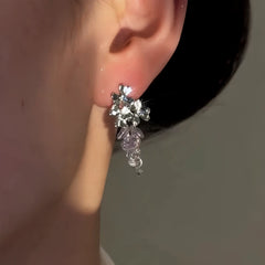 Model showcasing the dangle and style of the 14K Gold-Plated Elegant Zircon Grape Cluster Crystal Earrings