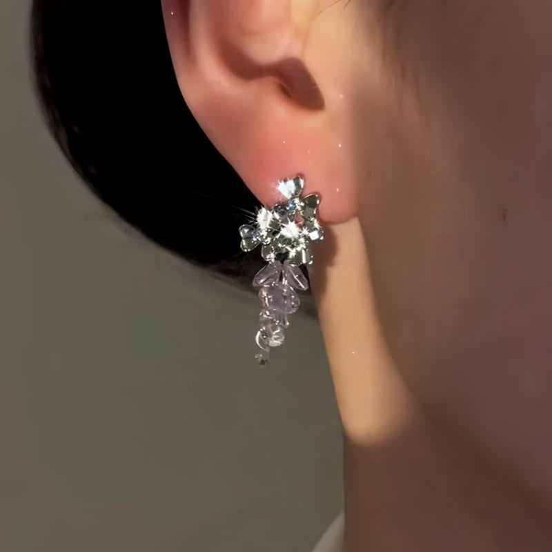 Close-up detail of the sparkling zircons and plating on the purple drop earrings