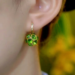 Close-up detail of the sparkling zircons and plating on the green drop earrings