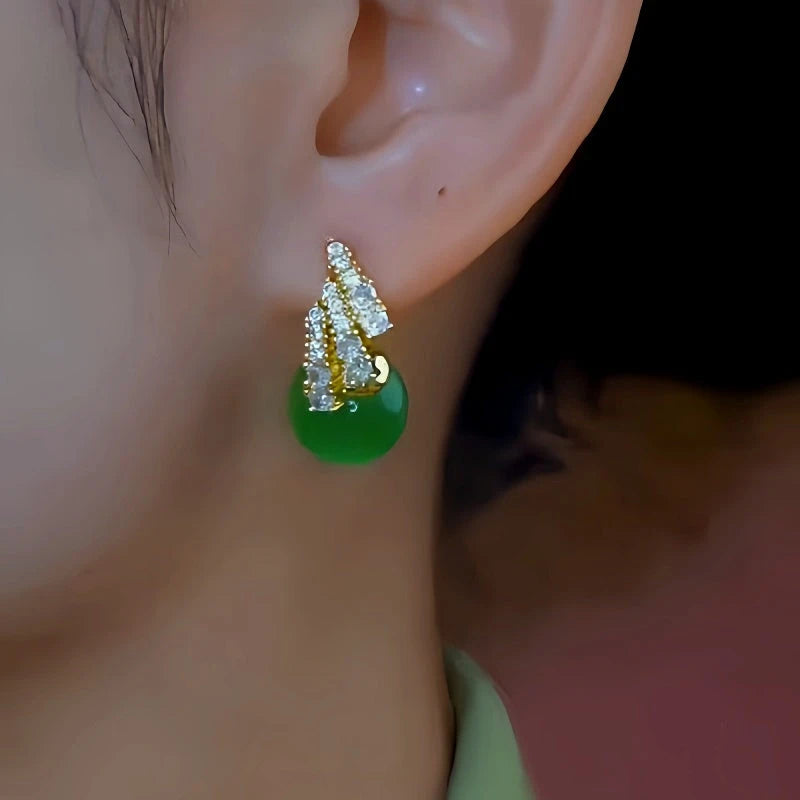 Model showcasing the dangle and style of the 14K Gold-Plated Elegant Zircon Green Bead Earrings
