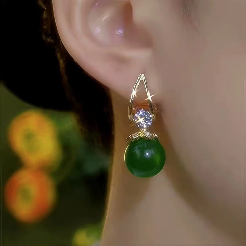 Close-up detail of the sparkling zircons and plating on the green drop earrings
