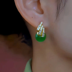 Close-up detail of the sparkling zircons and plating on the green drop earrings