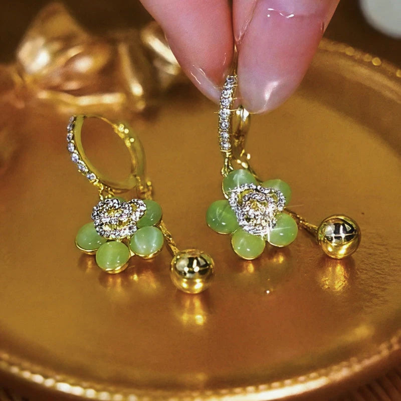 Close-up detail of the sparkling zircons and plating on the green flower earrings