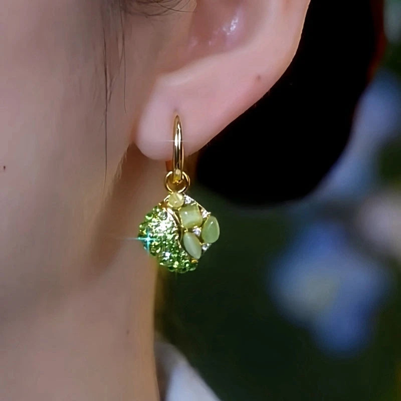 Close-up detail of the sparkling zircons and plating on the green drop earrings