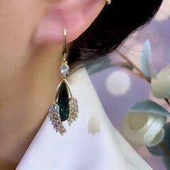 Close-up detail of the sparkling zircons and plating on the green threader earrings