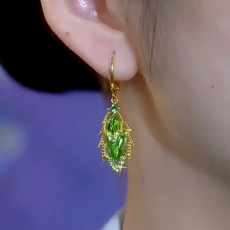 Close-up detail of the sparkling zircons and plating on the green leaf earrings