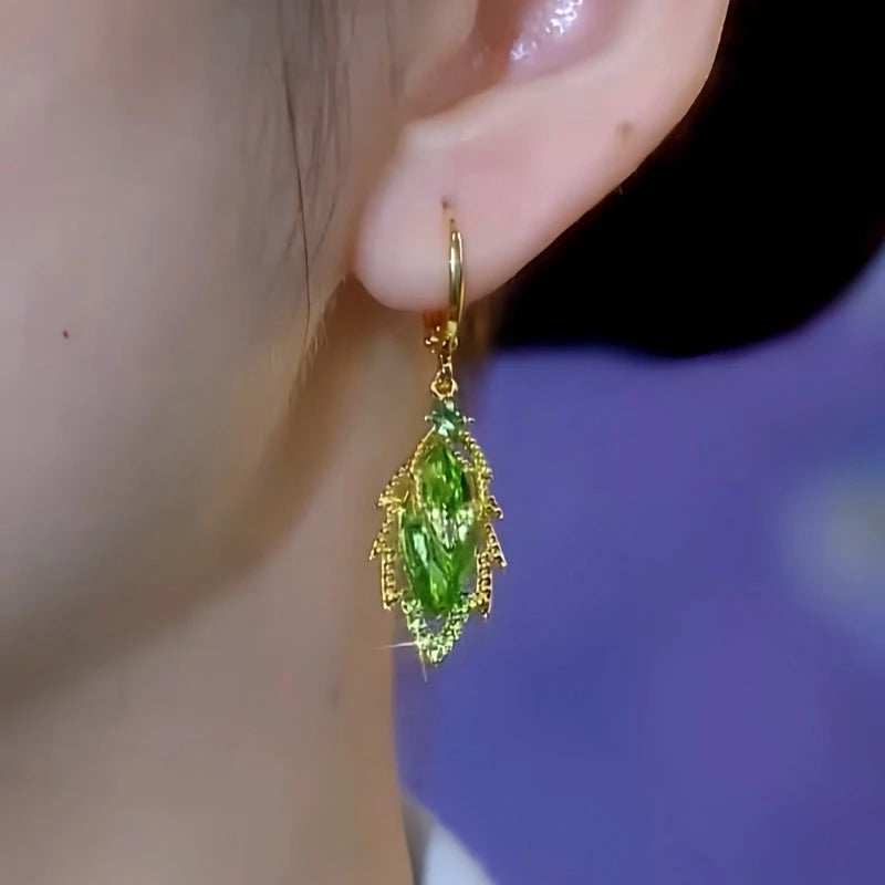 Model showcasing the dangle and style of the 14K Gold-Plated Elegant Zircon Green Crystal Leaf Earrings