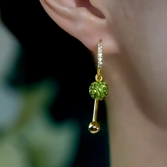 Model showcasing the dangle and style of the 14K Gold-Plated Elegant Zircon Green Diamod Ball Tassel Earrings