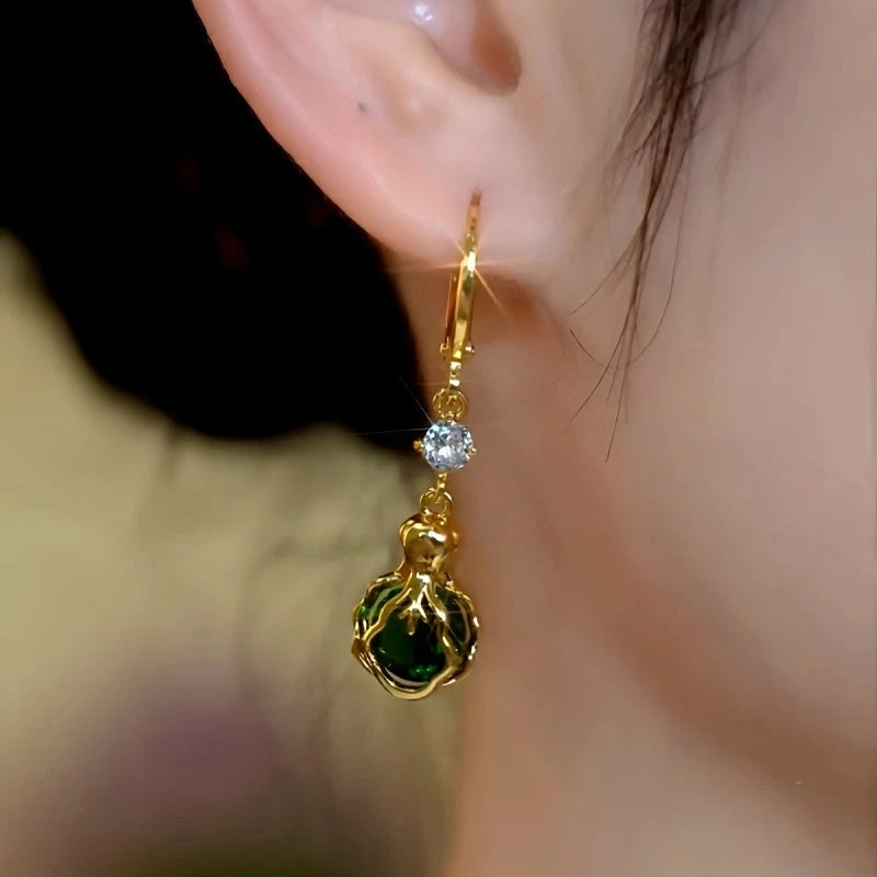 Close-up detail of the sparkling zircons and plating on the green drop earrings