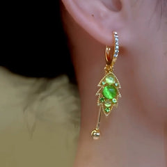 Close-up detail of the sparkling zircons and plating on the green tassel earrings