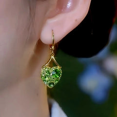 Close-up detail of the sparkling zircons and plating on the green heart earrings