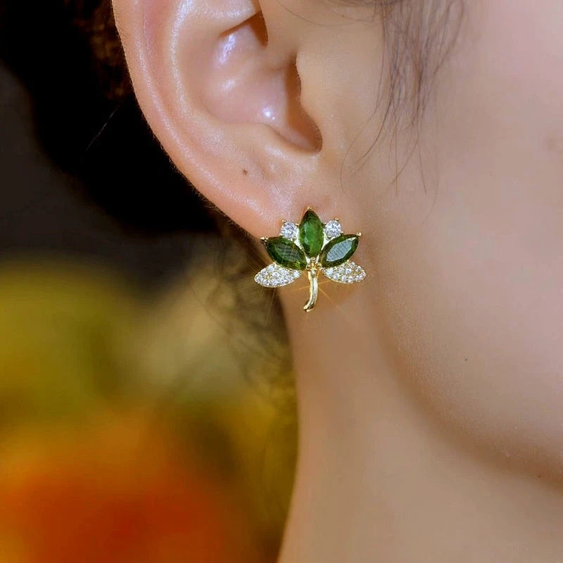 Close-up detail of the sparkling zircons and plating on the green leaf earrings