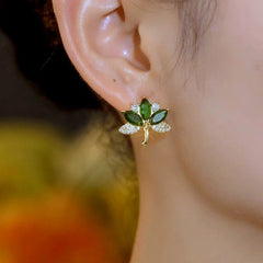 Close-up detail of the sparkling zircons and plating on the green leaf earrings