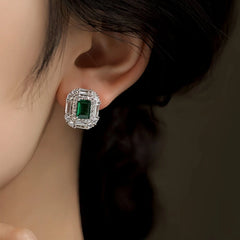 Model showcasing the dangle and style of the 14K Gold-Plated Elegant Zircon Green Diamond Stud Earrings