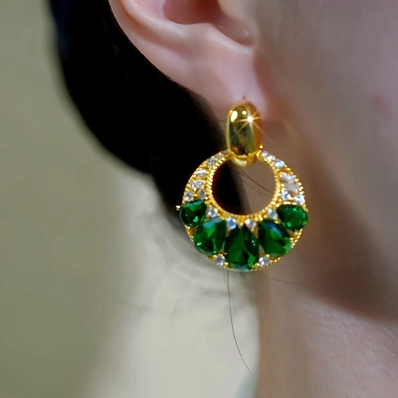 Model showcasing the dangle and style of the 14K Gold-Plated Elegant Zircon Green Diamond Tassel Earrings