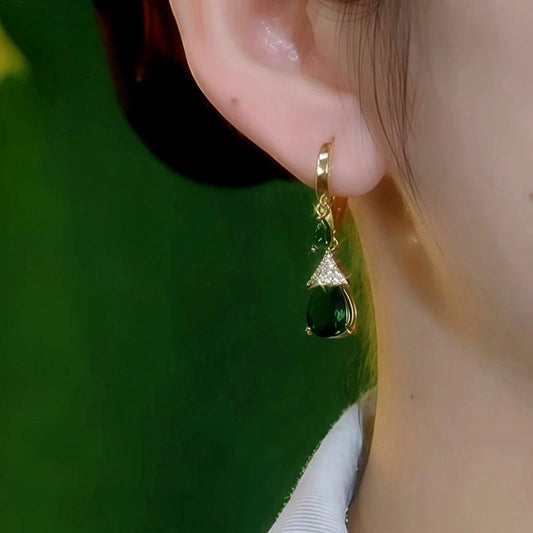 Model showcasing the dangle and style of the 14K Gold-Plated Elegant Zircon Green Diamond Water Drop Earrings