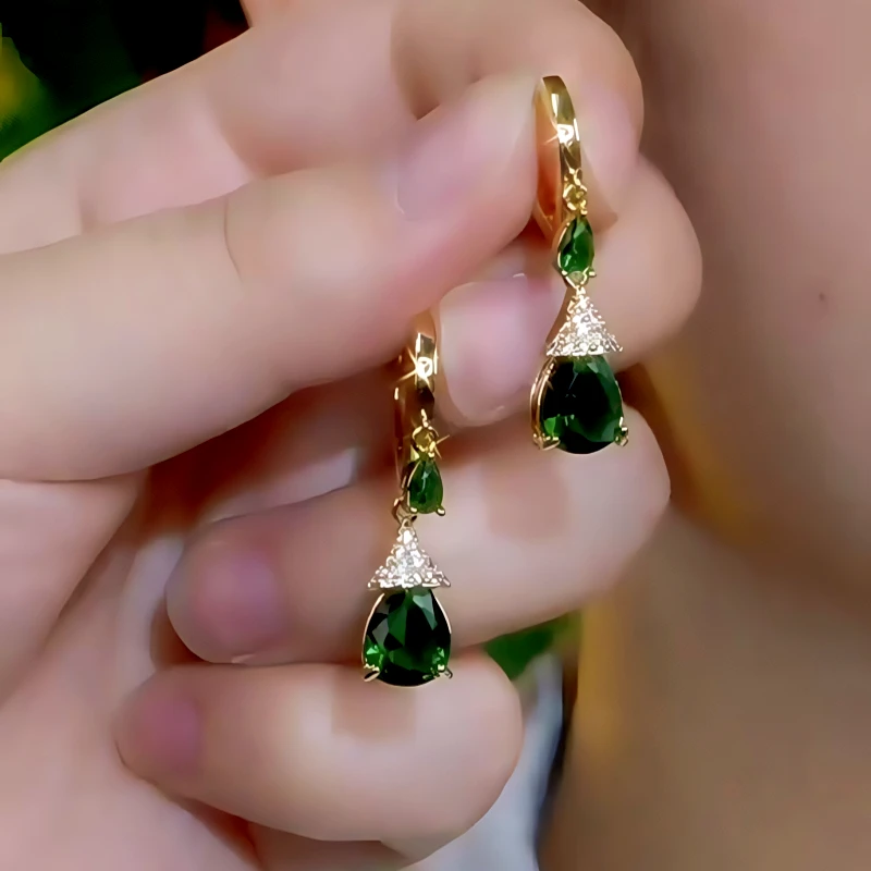Close-up detail of the sparkling zircons and plating on the green drop earrings