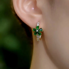 Model showcasing the dangle and style of the 14K Gold-Plated Elegant Zircon Green Flower Hoop Earrings