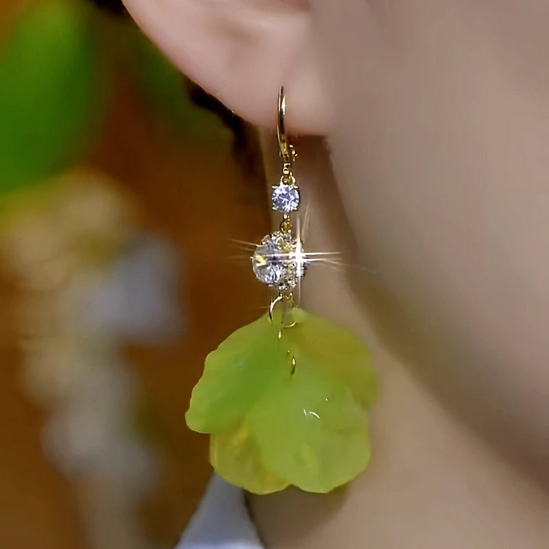 Model showcasing the dangle and style of the 14K Gold-Plated Elegant Zircon Green Flower Tassel Earrings