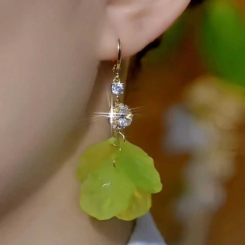 Close-up detail of the sparkling zircons and plating on the green tassel earrings