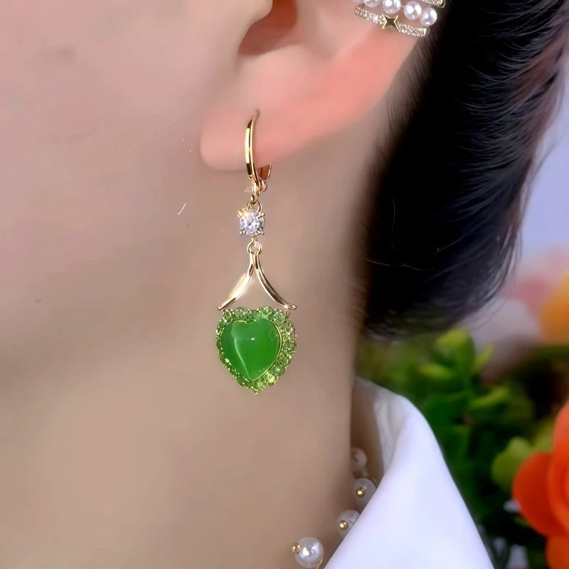 Model showcasing the dangle and style of the 14K Gold-Plated Elegant Zircon Green Heart Earrings