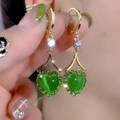 Close-up detail of the sparkling zircons and plating on the green heart earrings