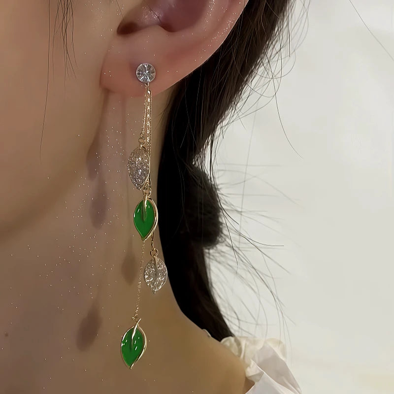 Model showcasing the dangle and style of the 14K Gold-Plated Elegant Zircon Green Leaf Tassel Earrings