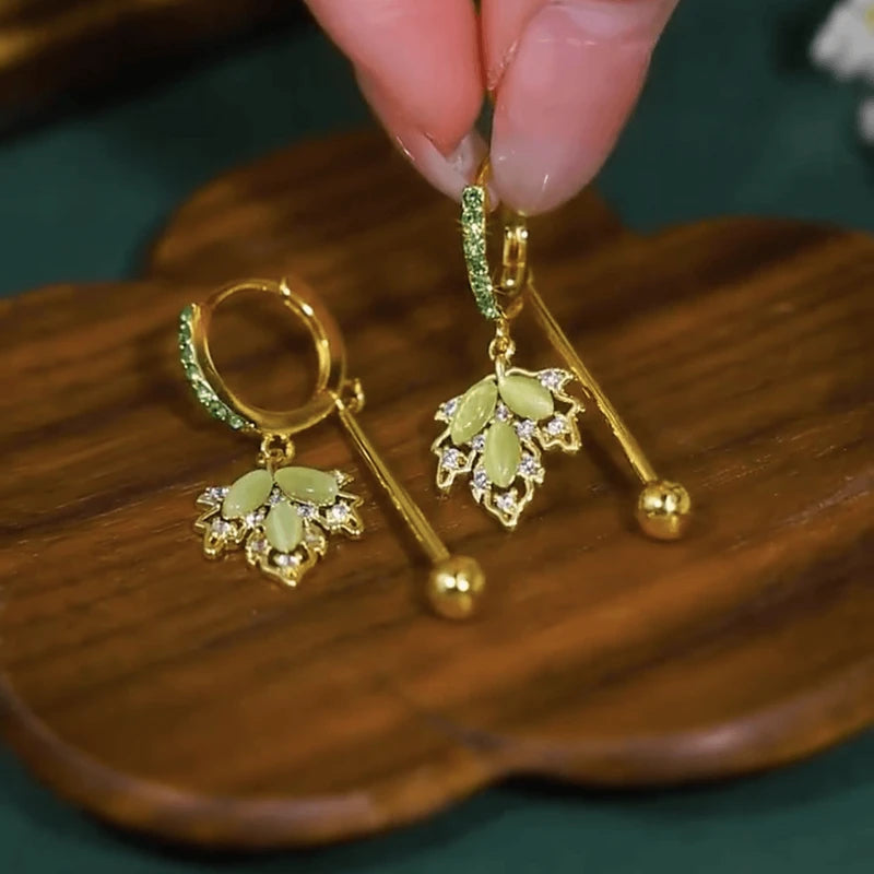 Angled view of the 14K Gold-Plated Elegant Zircon Green Maple Leaf Earrings