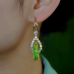 Close-up detail of the sparkling zircons and plating on the green tassel earrings