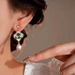 Model showcasing the dangle and style of the 14K Gold-Plated Elegant Zircon Green Mountain Pearl Tassel Earrings