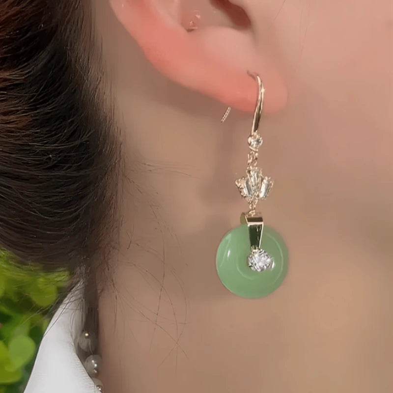 Close-up detail of the sparkling zircons and plating on the green threader earrings