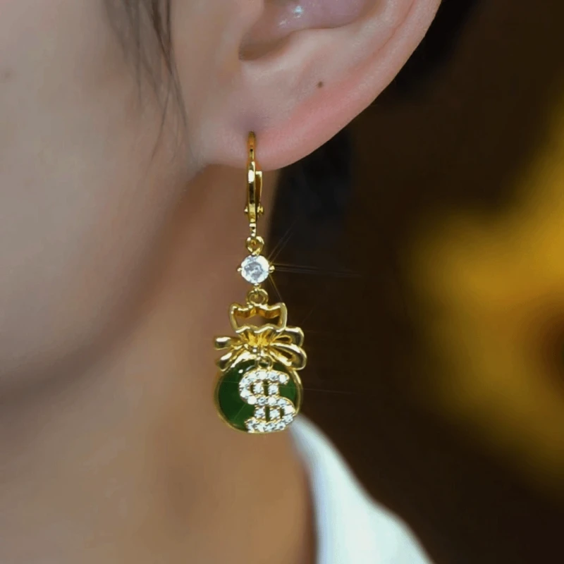 Close-up detail of the sparkling zircons and plating on the green drop earrings
