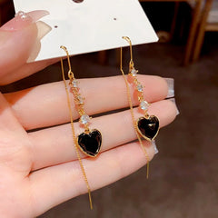 Angled view of the 14K Gold-Plated Elegant Zircon Heart-Design Tassel Threader Earrings